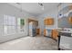 Well-lit kitchen with stainless steel appliances and updated tile floors at 1321 Land Grant Rd, Charlotte, NC 28217