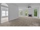 Open living room with a fireplace and large windows allowing natural light at 1321 Land Grant Rd, Charlotte, NC 28217
