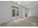 Bright living room featuring a fireplace, natural light, and neutral carpet at 1321 Land Grant Rd, Charlotte, NC 28217