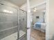View from bathroom, with shower, to bedroom with area rug and tray ceiling at 1456 Augustus Beamon Dr, Indian Trail, NC 28079