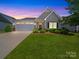 Charming single-story home with a manicured lawn, gray siding, and a two-car garage at 1456 Augustus Beamon Dr, Indian Trail, NC 28079