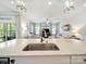 Bright open-concept home featuring a spacious kitchen island with sink and pendant lighting over looking the living area at 1456 Augustus Beamon Dr, Indian Trail, NC 28079
