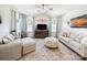 Bright living room with elegant decor, plush seating, and large windows providing natural light for a welcoming ambiance at 1456 Augustus Beamon Dr, Indian Trail, NC 28079