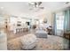 Open-concept living room with a chaise lounge, ottoman, and view of the kitchen at 1456 Augustus Beamon Dr, Indian Trail, NC 28079