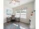 Bright office space with desk, office chair, shelves, and wood-look floors at 1456 Augustus Beamon Dr, Indian Trail, NC 28079