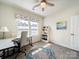 Bright office space with desk, office chair, shelves, and natural light at 1456 Augustus Beamon Dr, Indian Trail, NC 28079