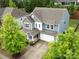 Stunning aerial view of a well-maintained home, showcasing its roof, landscaping, and surrounding neighborhood at 15630 Oleander Dr, Charlotte, NC 28278