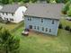 Aerial of backyard showcasing lush green lawn and custom grilling station and patio at 15630 Oleander Dr, Charlotte, NC 28278