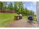 Charming backyard with brick patio, built-in grill, hanging chair, perfect for outdoor entertaining at 15630 Oleander Dr, Charlotte, NC 28278