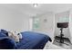 Bright bedroom with a blue comforter on the bed, neutral walls, and natural light from the window at 15630 Oleander Dr, Charlotte, NC 28278