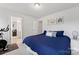 Comfortable bedroom with blue bedding, carpeted floor and en suite bathroom at 15630 Oleander Dr, Charlotte, NC 28278