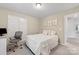 Comfortable bedroom with a full-sized bed, an office space, and neutral wall paint at 15630 Oleander Dr, Charlotte, NC 28278