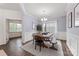 Light dining room with wood trim and floor, featuring a modern light fixture over a large wood table at 15630 Oleander Dr, Charlotte, NC 28278