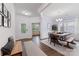 Bright dining room featuring hardwood floors, trim, and modern chandelier at 15630 Oleander Dr, Charlotte, NC 28278
