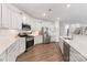 Modern kitchen with white cabinets, stainless steel appliances, and a center island and breakfast bar at 15630 Oleander Dr, Charlotte, NC 28278