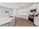 New kitchen boasting white cabinets, stainless steel appliances, and a large center island at 15630 Oleander Dr, Charlotte, NC 28278
