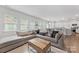 Bright living room boasts a large sectional sofa, wood coffee table, and lots of natural light at 15630 Oleander Dr, Charlotte, NC 28278