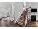 Inviting foyer with staircase and hardwood flooring plus a fireplace at 15630 Oleander Dr, Charlotte, NC 28278