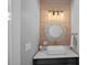 Stylish bathroom vanity with a round mirror and a modern, vessel sink at 17938 John Connor Rd, Cornelius, NC 28031