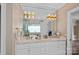 Bright bathroom featuring a double sink vanity, large mirror, and modern lighting fixtures at 17938 John Connor Rd, Cornelius, NC 28031
