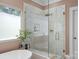 This bathroom features a frameless glass shower with rainfall showerhead and modern tub at 17938 John Connor Rd, Cornelius, NC 28031
