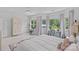 This bedroom features a large bed with a window view, a ceiling fan, and neutral decor at 17938 John Connor Rd, Cornelius, NC 28031