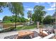 Beautiful deck overlooking the lake with outdoor seating and views of the landscaped backyard and swimming pool at 17938 John Connor Rd, Cornelius, NC 28031