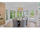 Bright dining room featuring a round table, six chairs, and large windows with scenic views at 17938 John Connor Rd, Cornelius, NC 28031