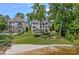 Expansive lawn leading up to a stately home with a backyard swimming pool and lush landscaping at 17938 John Connor Rd, Cornelius, NC 28031
