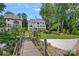 Beautiful backyard view with a stately home, lush greenery, and dock at 17938 John Connor Rd, Cornelius, NC 28031