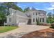 Elegant home showcasing beautiful architectural details, a manicured front yard, and a spacious driveway, offering curb appeal at 17938 John Connor Rd, Cornelius, NC 28031