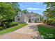 Elegant exterior view of this magnificent home, showcasing the well-manicured lawn and inviting driveway at 17938 John Connor Rd, Cornelius, NC 28031