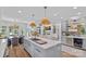 Open concept kitchen with a center island, modern appliances, and wine storage at 17938 John Connor Rd, Cornelius, NC 28031