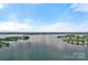 Expansive lake view showing the calm waters and tree-lined shore, offering a sense of tranquility and natural beauty at 17938 John Connor Rd, Cornelius, NC 28031