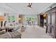 Elegant living room boasts high ceilings, french doors, and tasteful decor, and a fireplace at 17938 John Connor Rd, Cornelius, NC 28031
