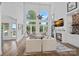 Bright, airy living room boasts high ceilings, a fireplace, and expansive windows offering beautiful views at 17938 John Connor Rd, Cornelius, NC 28031