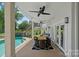 Covered patio area with dining table and a view of the pool and beautifully landscaped backyard at 17938 John Connor Rd, Cornelius, NC 28031