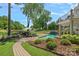 Backyard pool with brick patio, mature trees, lake views, and attractive landscaping at 17938 John Connor Rd, Cornelius, NC 28031