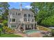 Stunning home featuring a pool, patio, and stairs leading up to a second-story balcony with large arched windows at 17938 John Connor Rd, Cornelius, NC 28031