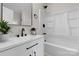 Modern bathroom features white vanity, black fixtures, and a shower/tub with white surround at 18 S Coulter Ave, Newton, NC 28658