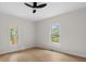 Bright bedroom with hardwood floors, white walls, and two windows allowing natural light at 18 S Coulter Ave, Newton, NC 28658