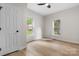 Bright bedroom with hardwood floors, white walls, two windows, and a white door at 18 S Coulter Ave, Newton, NC 28658