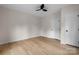 Bedroom with hardwood floors, light walls, ceiling fan, and a door to the closet at 18 S Coulter Ave, Newton, NC 28658