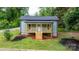 Charming cottage-style home featuring a cozy porch with wooden railing and fresh landscaping at 18 S Coulter Ave, Newton, NC 28658