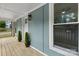 View of a wooden porch with white railing and green siding at 18 S Coulter Ave, Newton, NC 28658