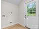Utility Room features hardwood flooring, white walls, and a white door to the backyard at 18 S Coulter Ave, Newton, NC 28658