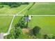 Aerial shot of a home on a large lot with mature trees and surrounding fields at 1825 Smyre Farm Rd, Newton, NC 28658