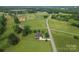 Overhead view of a home surrounded by green fields and a quiet country road at 1825 Smyre Farm Rd, Newton, NC 28658