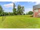 Expansive backyard featuring lush green grass, mature trees, and a partially fenced area at 1825 Smyre Farm Rd, Newton, NC 28658