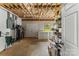 Unfinished basement with exposed ceiling, extra freezer, and space for storage at 1825 Smyre Farm Rd, Newton, NC 28658